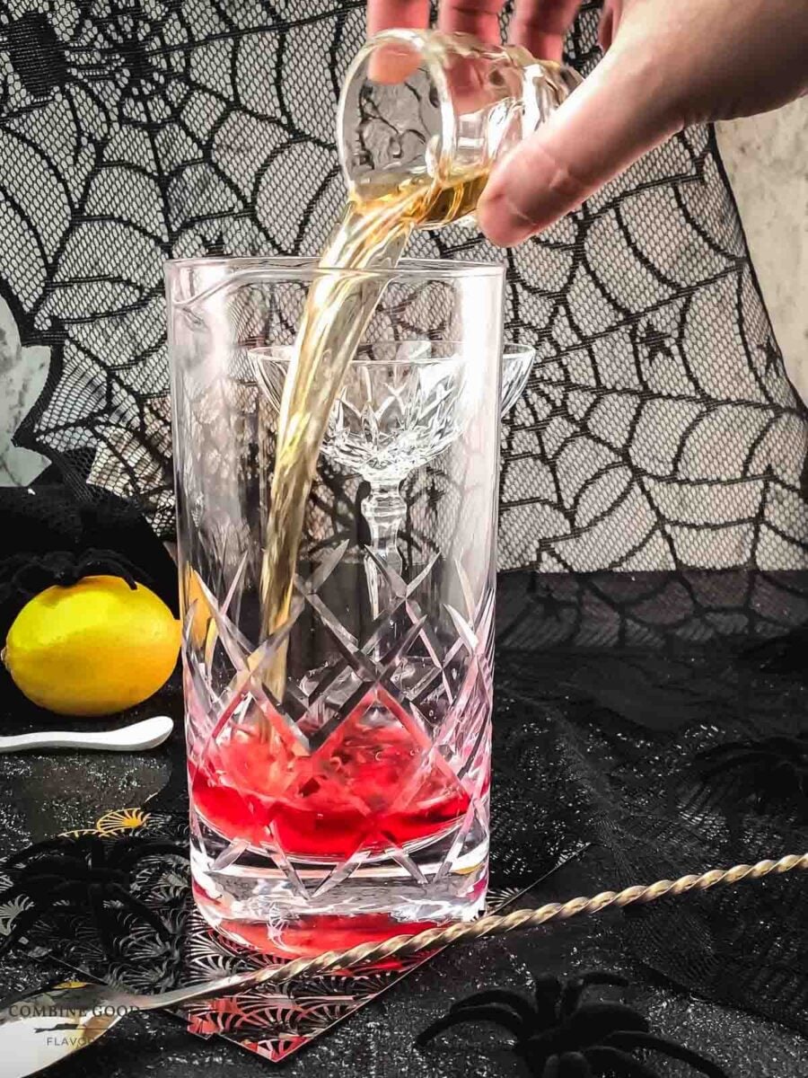 Add bourbon to the mixing glass.