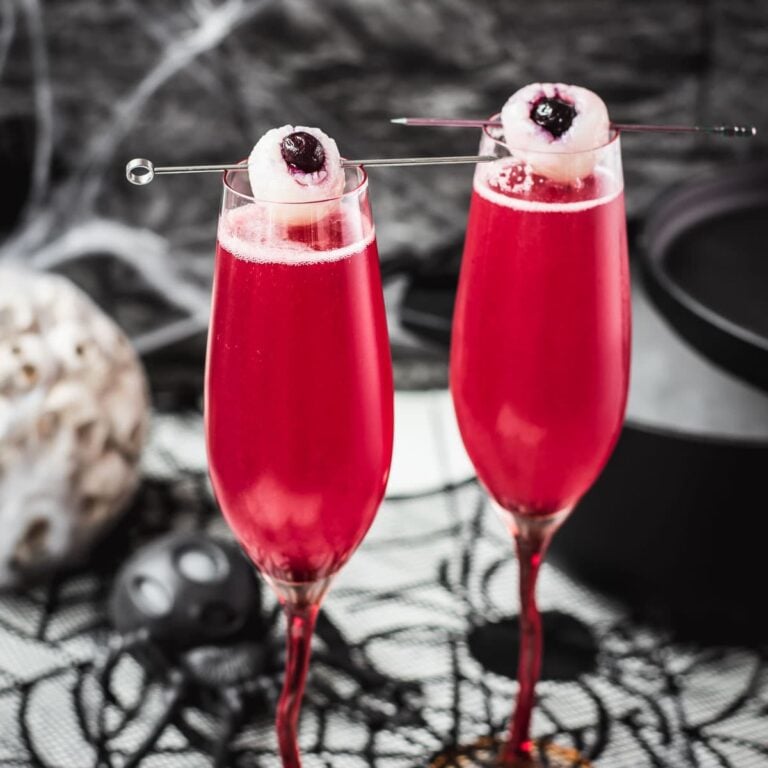 Spooky red Halloween cocktails, garnished with lychee eyeballs and served in a spooky location.