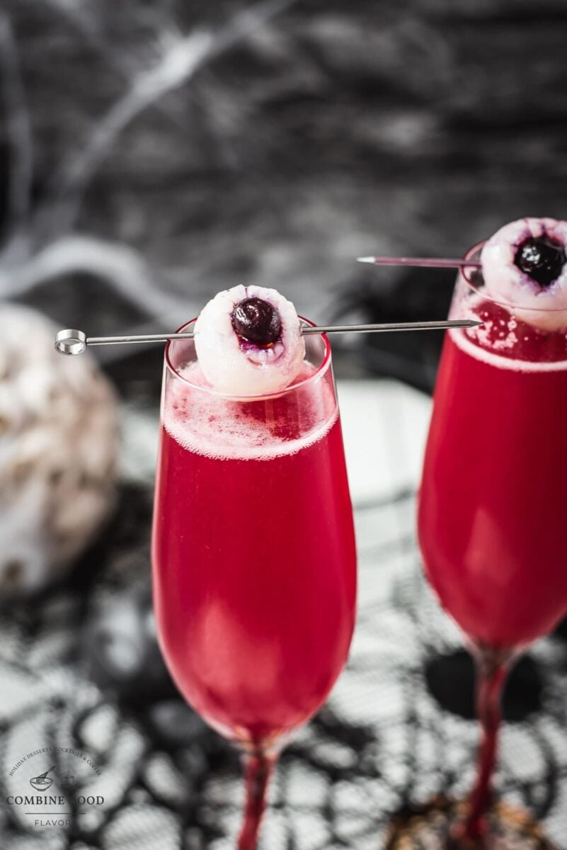 Spooky red Halloween cocktails, garnished with lychee eyeballs and served in a spooky location.