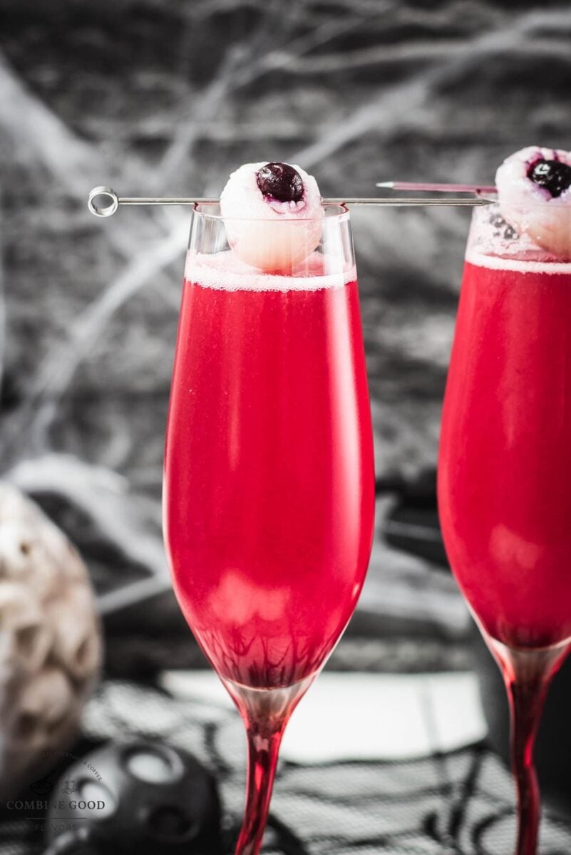 Spooky red Halloween cocktails, garnished with lychee eyeballs and served in a spooky location.