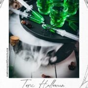 Toxic green Halloween Jello shot syringes surrounded by spooky fog