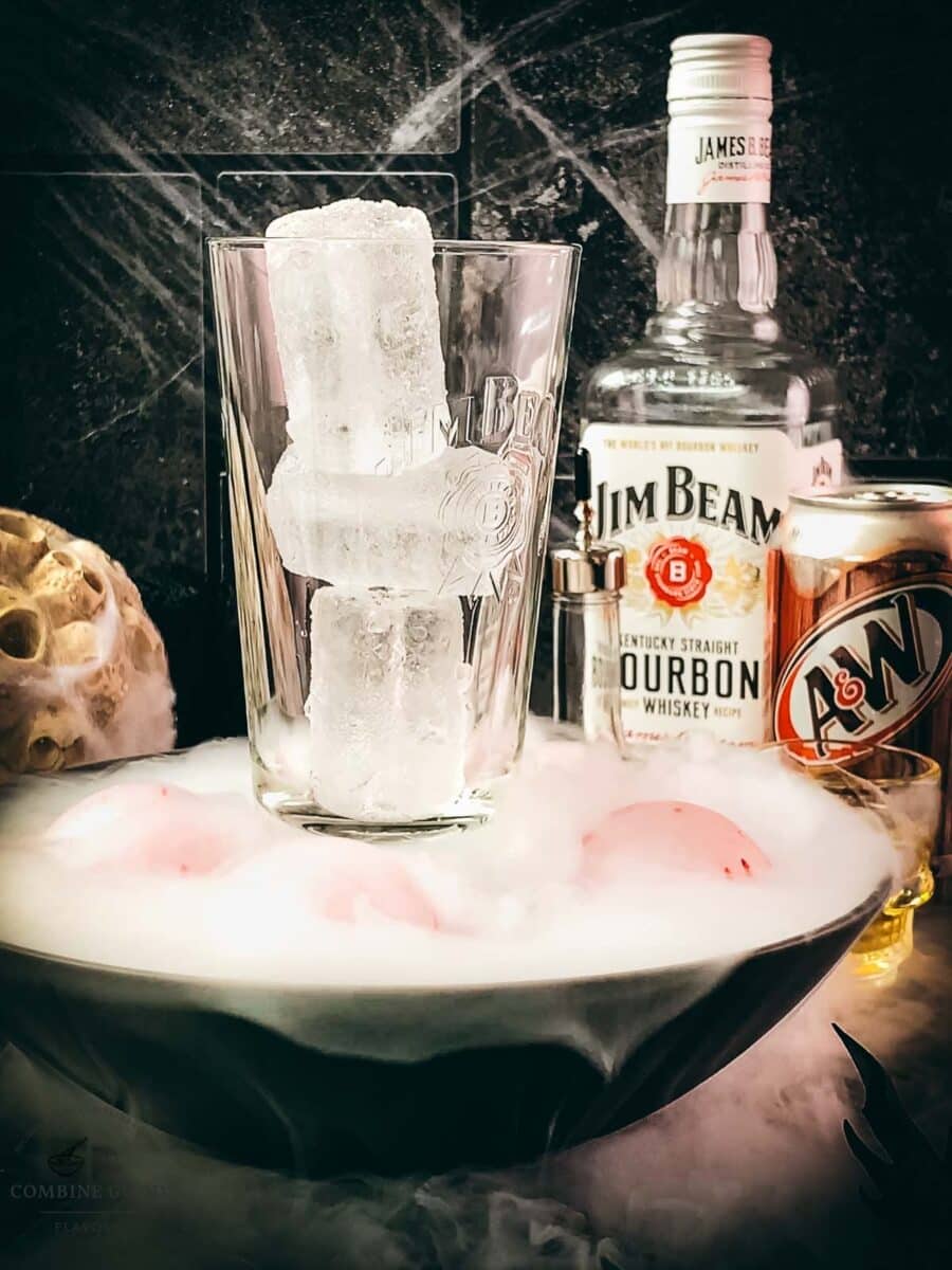 Tall cocktail glass filled with ice for a bourbon and root beer cocktail.