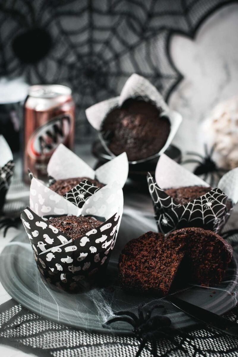 Halloween chocolate root beer muffins with a bubbling cauldron and spiderweb decorations