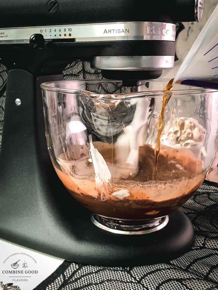Pouring root beer into chocolate muffin batter
