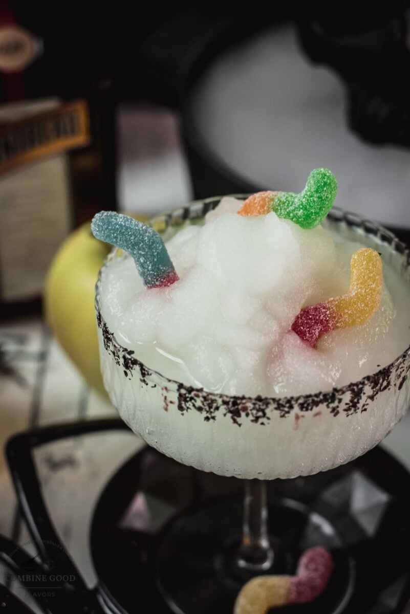 Gummy worms tucked into a bright green frozen margarita