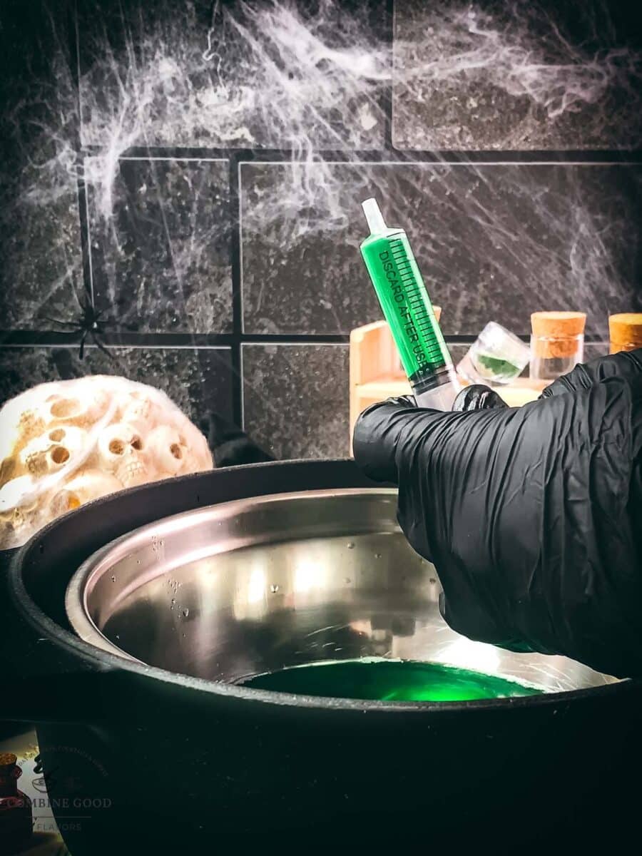 Green Halloween Jello shot syringes before chilling