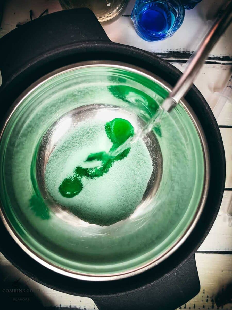 Pouring boiling water over lime gelatin for Jello shots