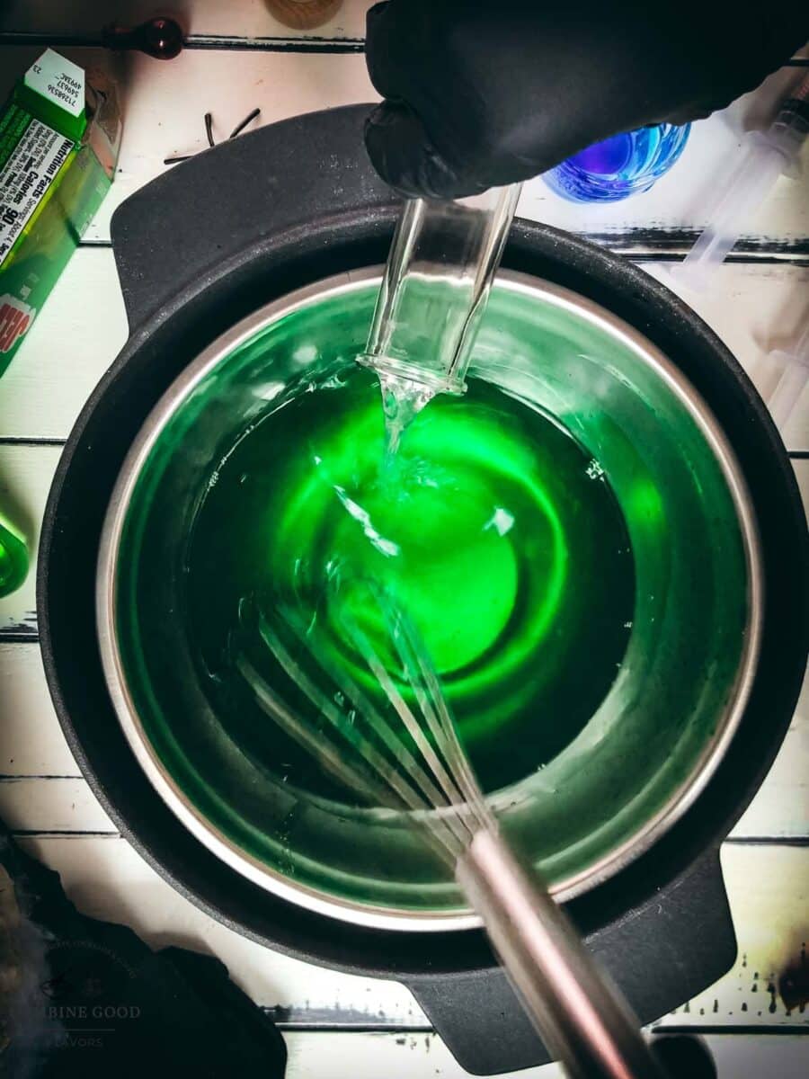 Adding vodka and blue curaçao to lime Jello mixture