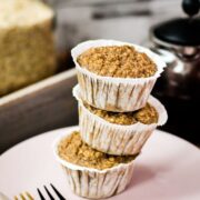A magnificent tower of banana oatmeal muffins on a wooden tray. Behind it, delicious red tea.
