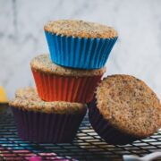 A cute little tower of lemon poppy seed muffins, arranged on a cooling rack.