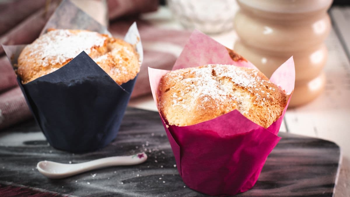 Cute angel food muffins, placed on marbled plate and served with a delicious cafe latte.