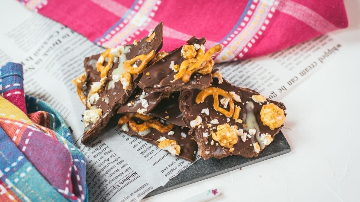 Delicious salted caramel popcorn bark placed on black slate.