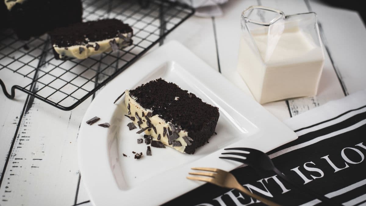 Divine chocolate buttermilk loaf cake with white chocolate frosting, sprinkled with chocolate shavings.