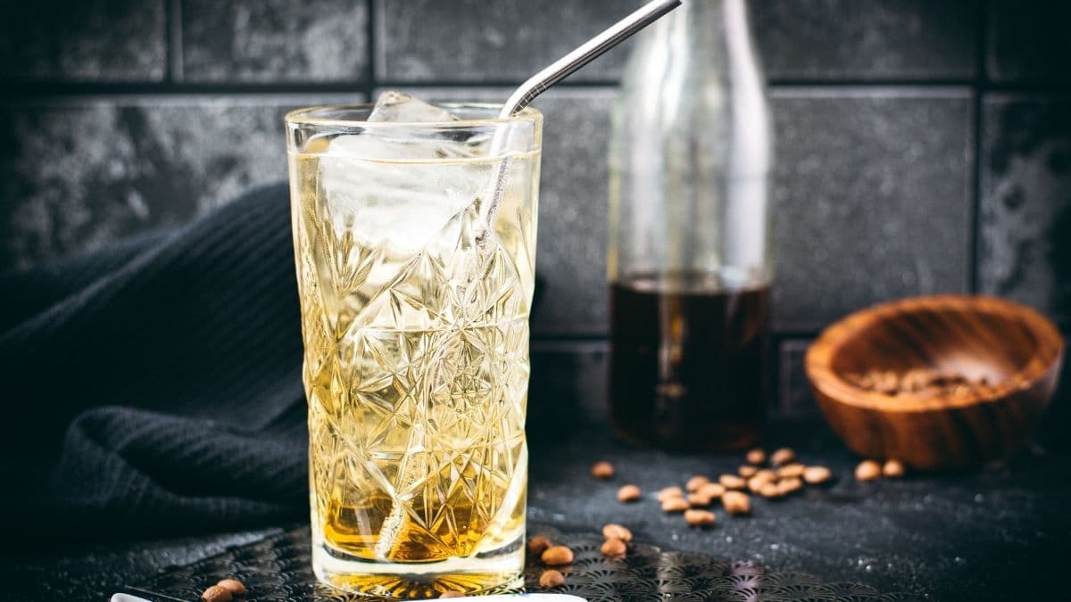 Highball glass filled with a delicious, golden-colored coffee soda.