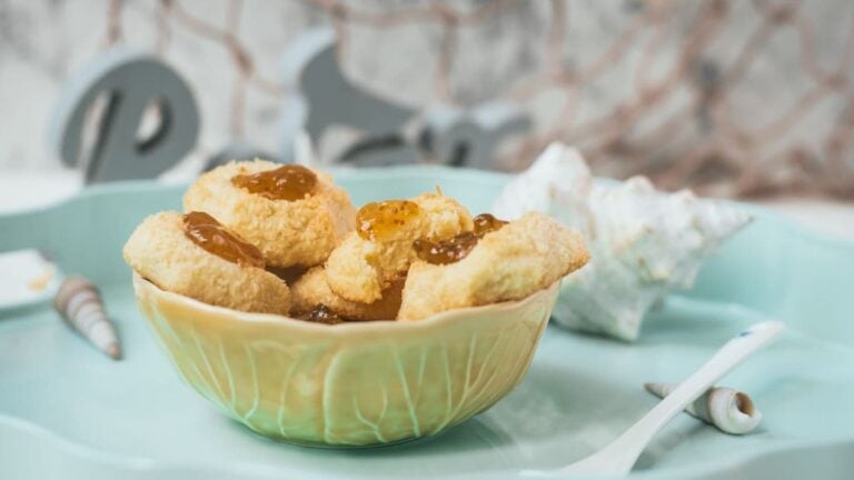 Delicious fig jam cookies, placed in a yellow bowl, on cookie is already missing a bite.