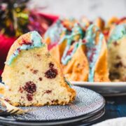 Slice of firecracker bundt cake. Placed on white blue plates.