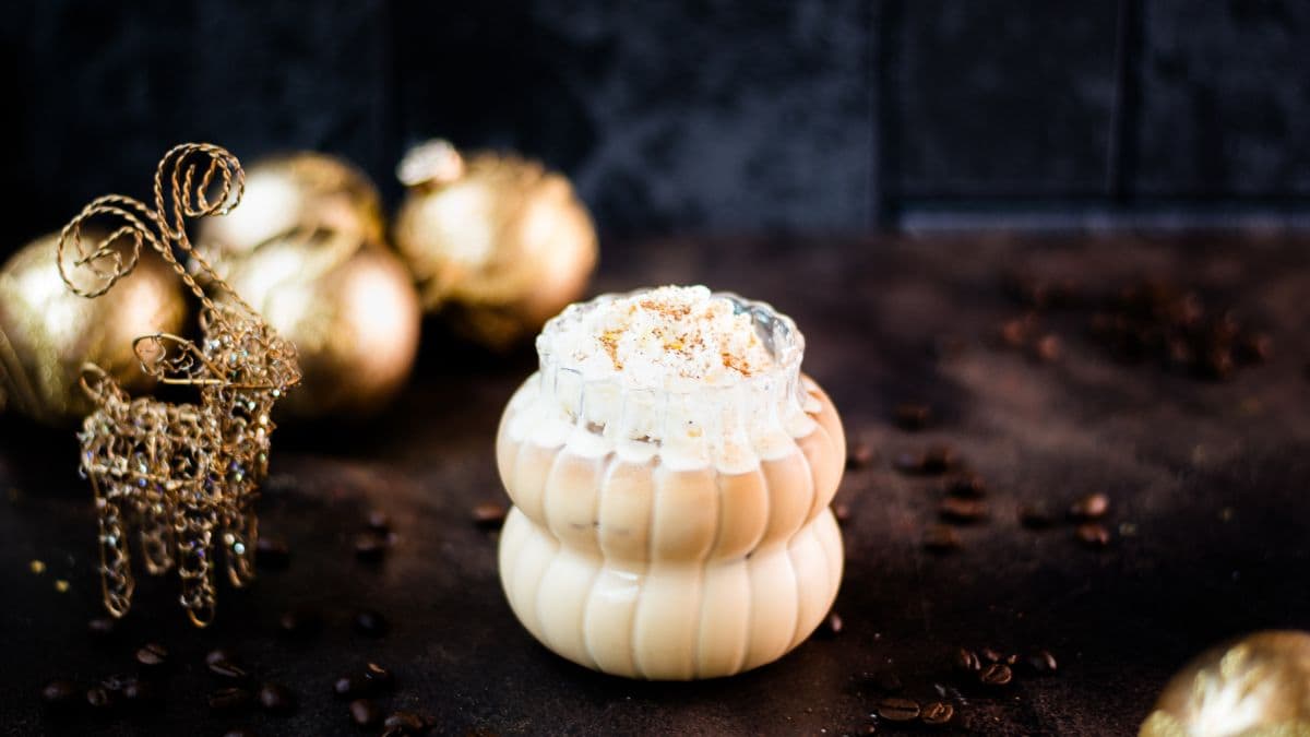 Delicious iced eggnog latte, garnished with heavy cream and dusted with ground cinnamon.