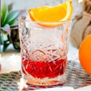 Gorgeous Negroni cocktail, served with a juice orange wedge.