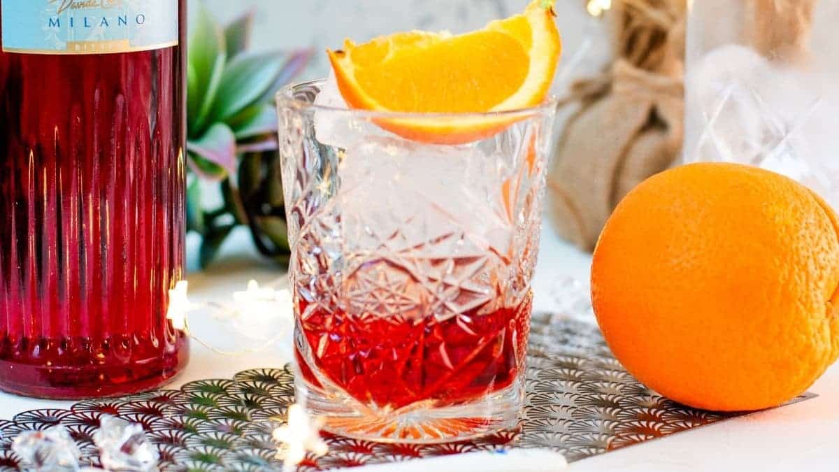 Gorgeous Negroni cocktail, served with a juice orange wedge.