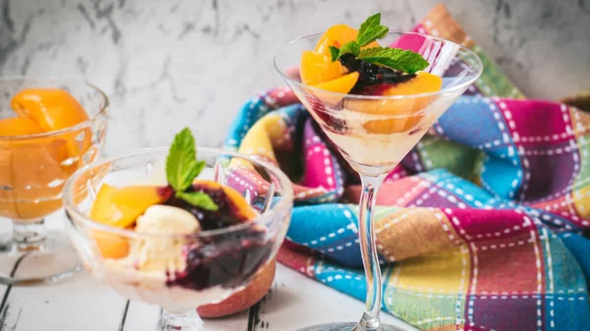 Elegant peach melba, served in cocktail glass.