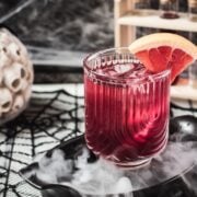 Spooky bloody sea breeze cocktail, served in a beautiful glass. Placed in a smoking black bowl.