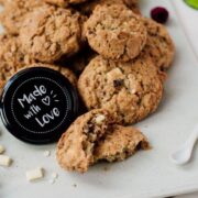 Raspberry macadamia oatmeal white chocolate chip cookies placed on white plate.