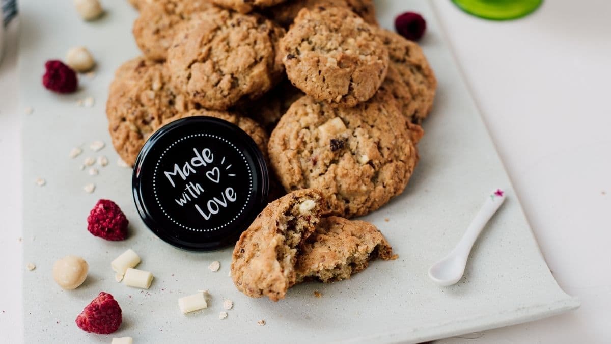 Raspberry macadamia oatmeal white chocolate chip cookies placed on white plate.