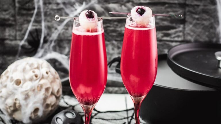 Spooky red Halloween cocktails, garnished with lychee eyeballs and served in a spooky location.